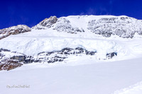 Powder snow blows up from the mountains. |OFa1022|